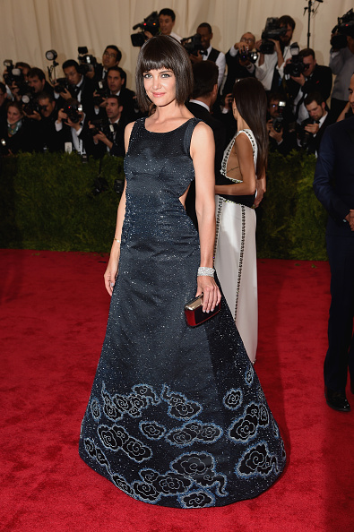 Katie Holmes with a bob wig wearing a cutout Zac Posen gown, Roger Vivier shoes and custom bag, and Chopard jewelry.